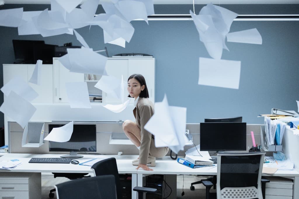 An office with papers in the air, the operation scattered across places